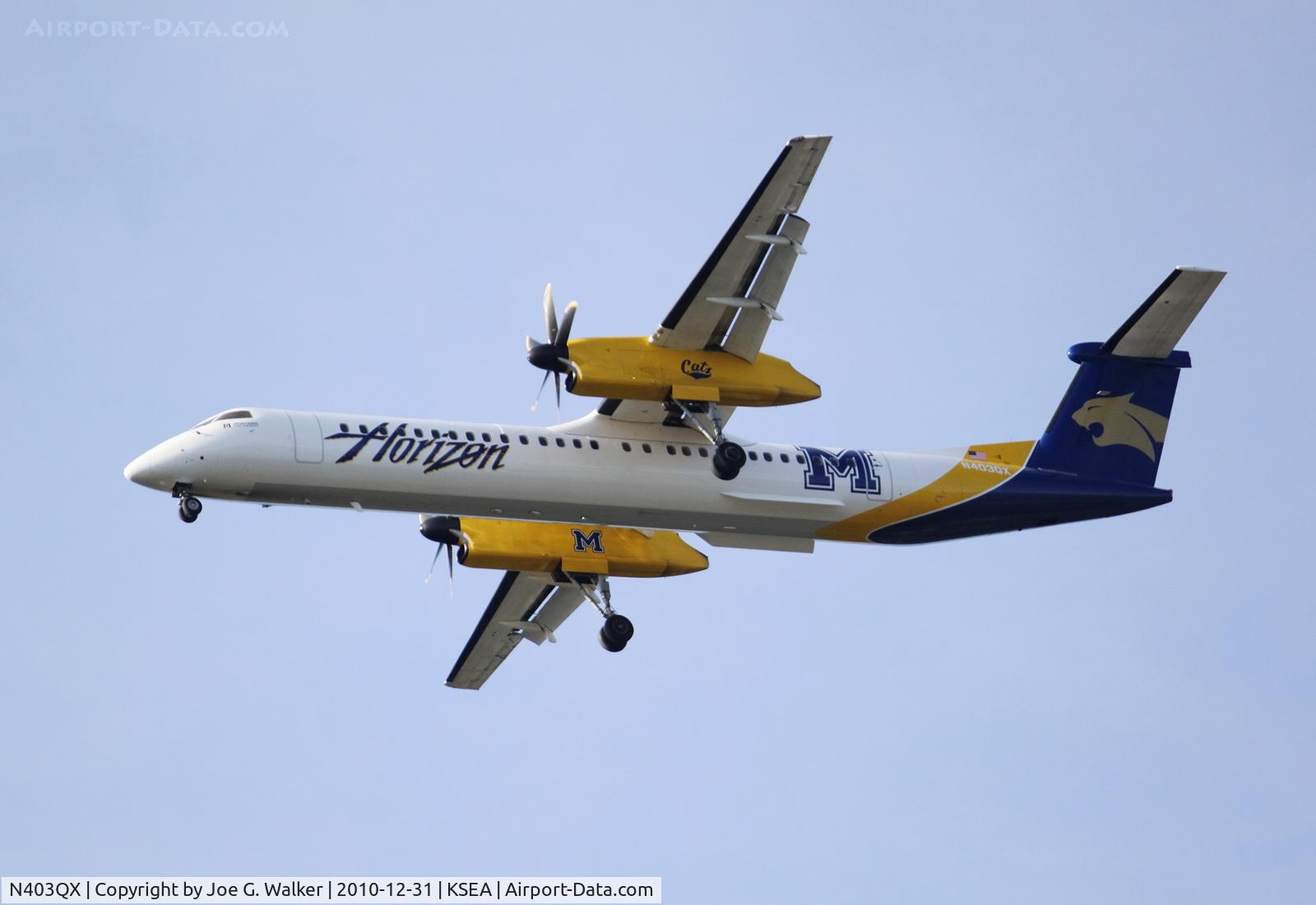 N403QX, 2001 De Havilland Canada DHC-8-402 Dash 8 C/N 4037, Seen in the colors of the Montana State University Bobcats is N403QX. Aircraft seen on approach to SEA.