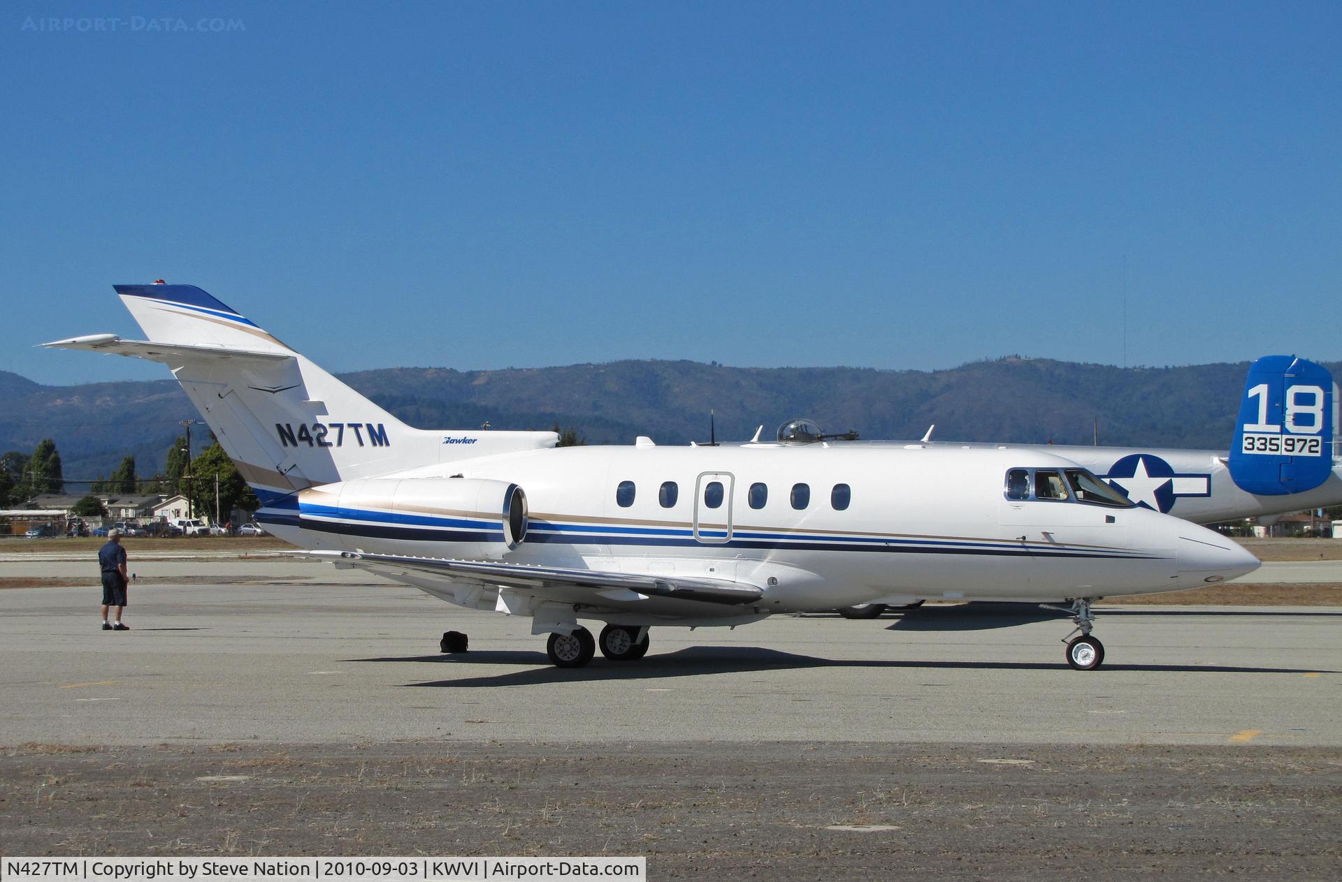 N427TM, 2005 Raytheon Hawker 800XP C/N 258720, Aircraft Holdings Raytheon Hawker 800XP at KWVI with TB-25N N125AZ #18 in background during 2010 Watsonville Fly-In