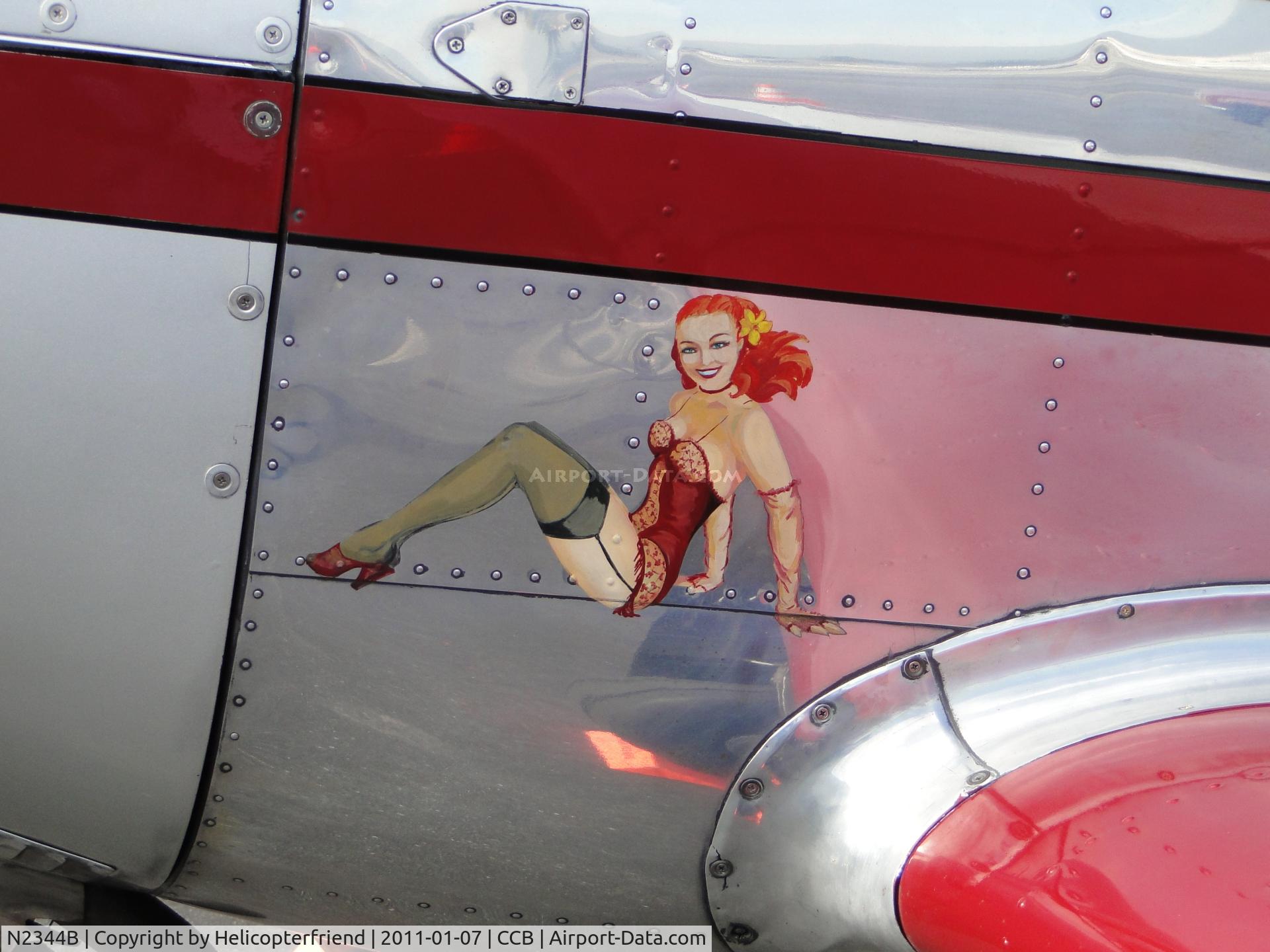 N2344B, 1948 Globe GC-1B Swift C/N 3644, Young Lady riding on the nose of the ship