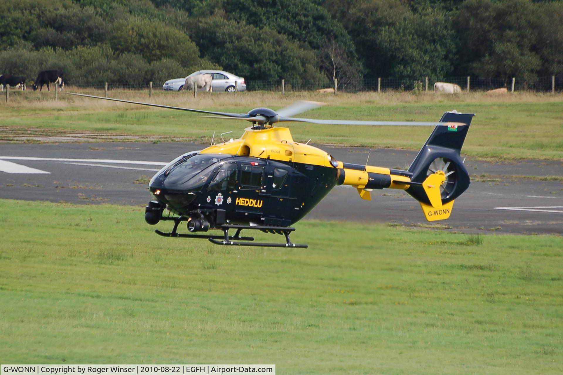 G-WONN, 2007 Eurocopter EC-135T-2+ C/N 0597, South and East Wales Police Air Support Unit helicopter (Police 32) visiting Swansea Airport. Marked POLICE on the starboard side.