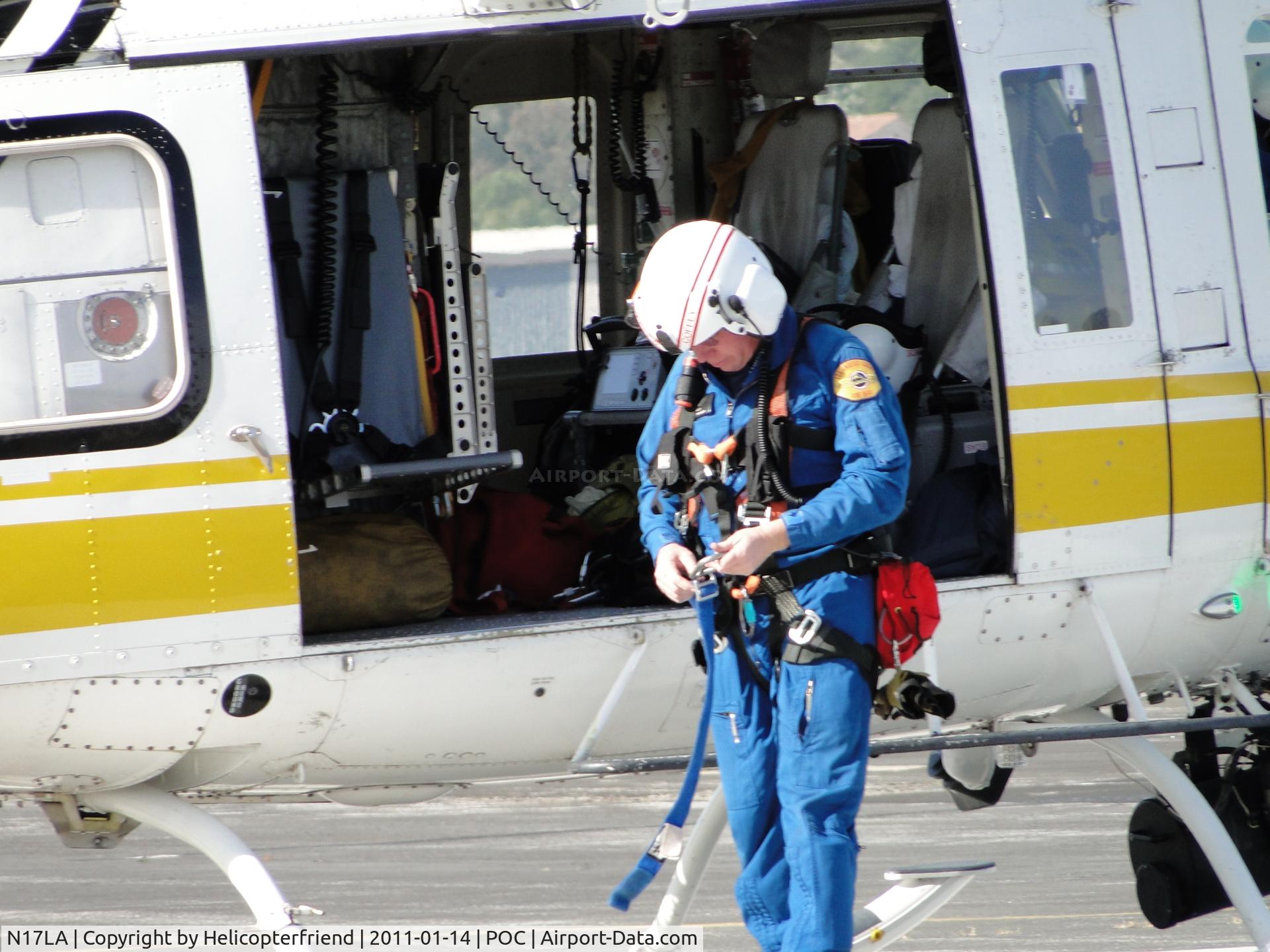 N17LA, 1992 Bell 412 C/N 36044, Taking off the rescue harness the crew member uses when doing a hoisting rescue