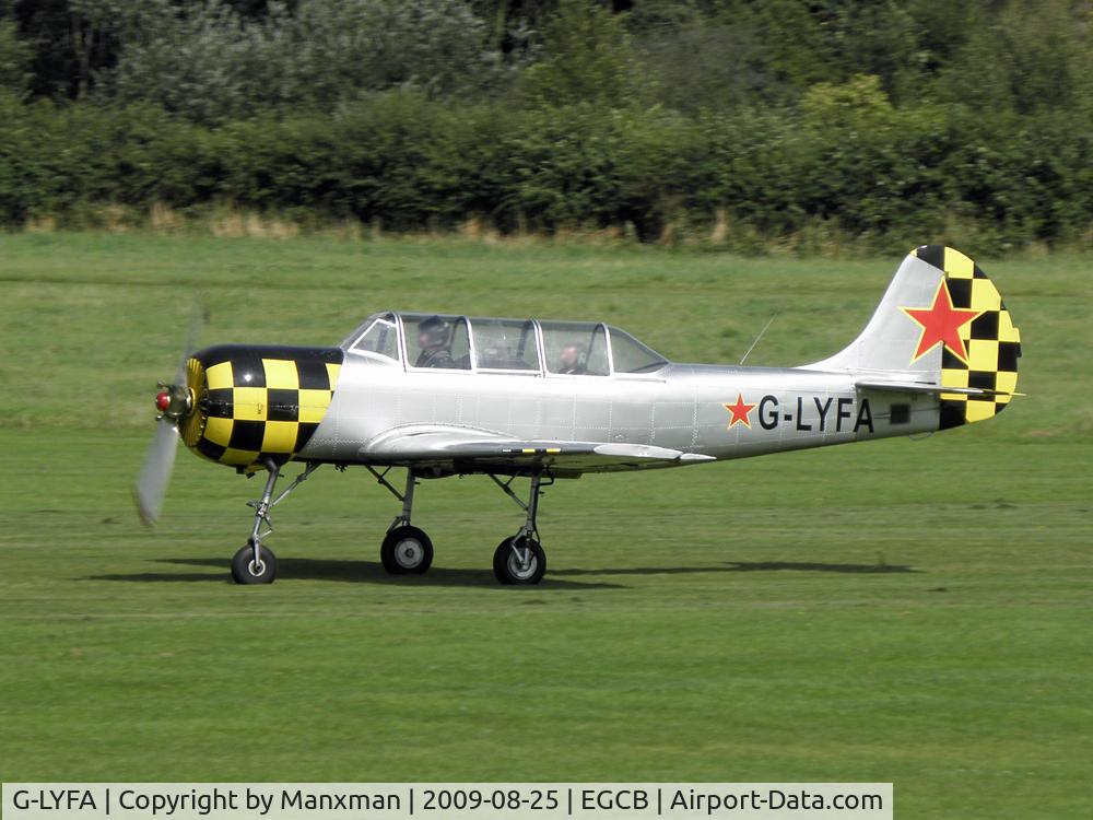 G-LYFA, 1982 Yakovlev Yak-52 C/N 822608, Yak G-LYFA departs Barton