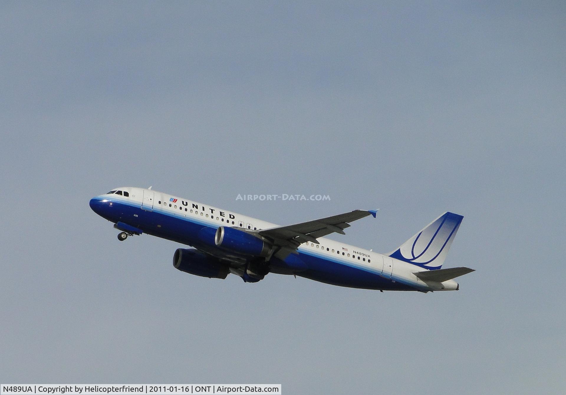 N489UA, 2002 Airbus A320-232 C/N 1702, Gaining altitude after take off fronway 26R, notice wheels coming up