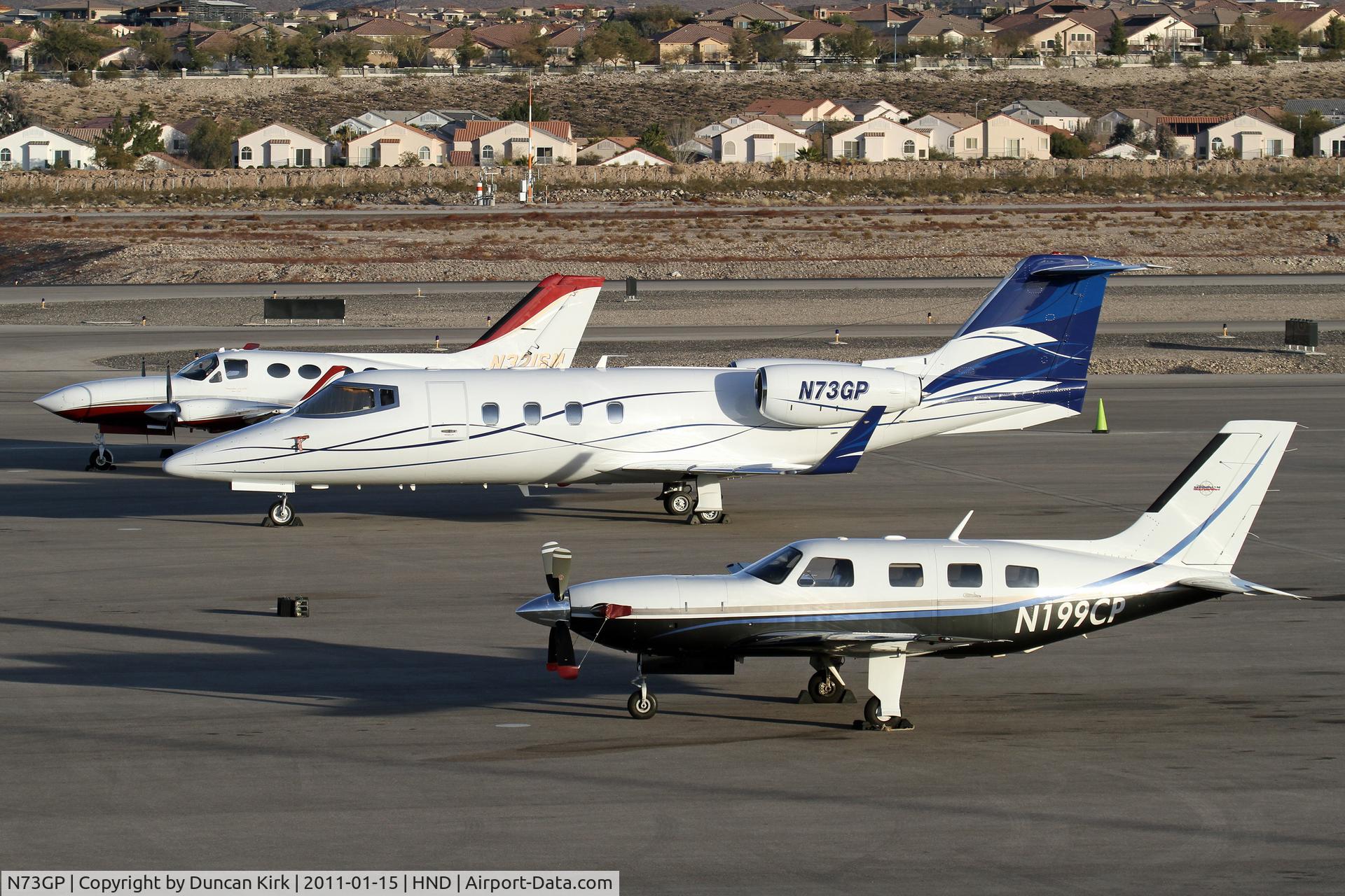 N73GP, 1986 Gates Learjet 55B C/N 55-127, N73GP shares the ramp with other corporate aircraft at Henderson, NV