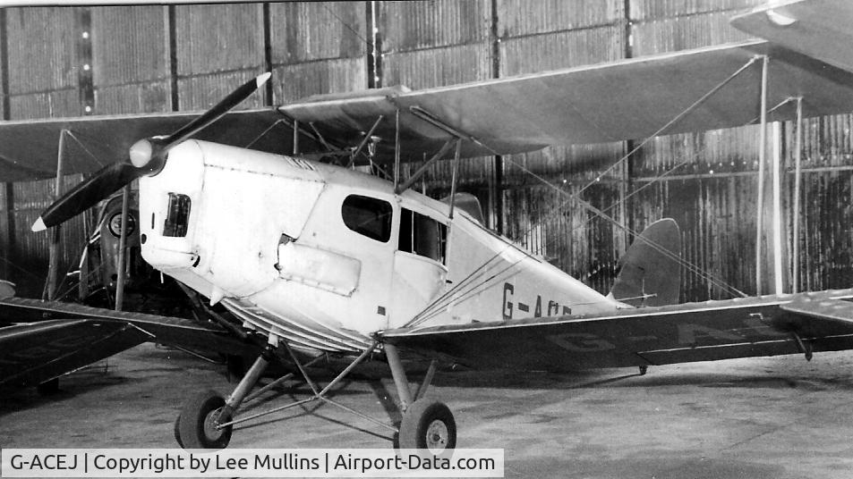 G-ACEJ, 1933 De Havilland DH.83 Fox Moth C/N 4069, G-ACEJ in the blister hangar at Old Warden before being destroyed by fire after a Beech Sundowner crashed onto it during a failed go around. The remains were just the metal parts, which somehow morphed into a new G-ACEJ...