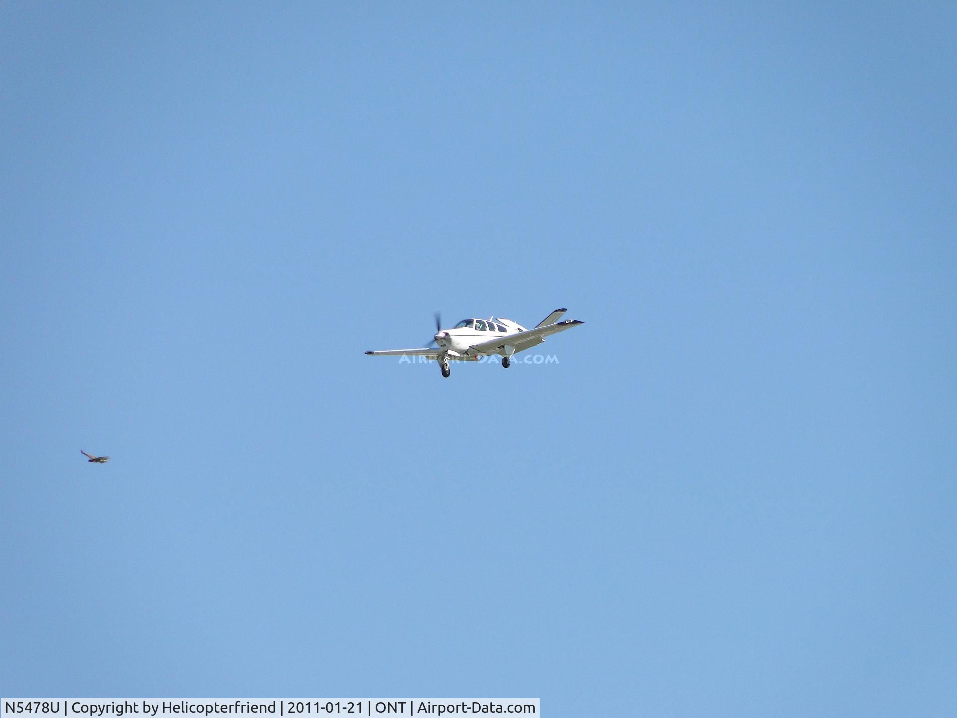 N5478U, 1967 Beech V35 Bonanza C/N D-8566, Appears to be flying parallel with one of the local hawks, on final to runway 26R