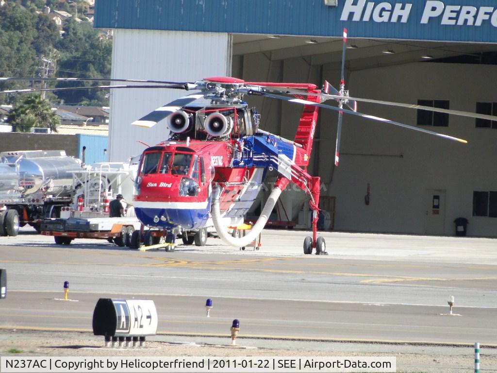N237AC, 1970 Erickson S-64F Skycrane C/N 64095, San Diego Gas & Electric, Sun Bird, parked near High Performance Aircraft hanger, with support and fuel trucks on the side
