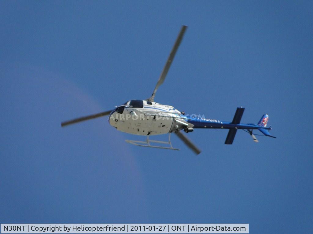 N30NT, 2007 Eurocopter AS-350B-2 Ecureuil C/N 4352, Passing directly overhead at the westbound approach area. Ontario PD was assisting units with an aerial search