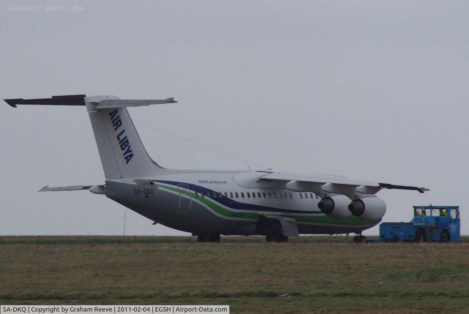 5A-DKQ, 1991 British Aerospace BAe.146-300 C/N E3191, Under tow on a dull and windy afternoon.