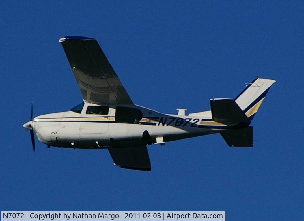 N7072, Cessna T210M Turbo Centurion C/N 21061962, Seen flying south over Ocean Beach Pier, San Diego, California.