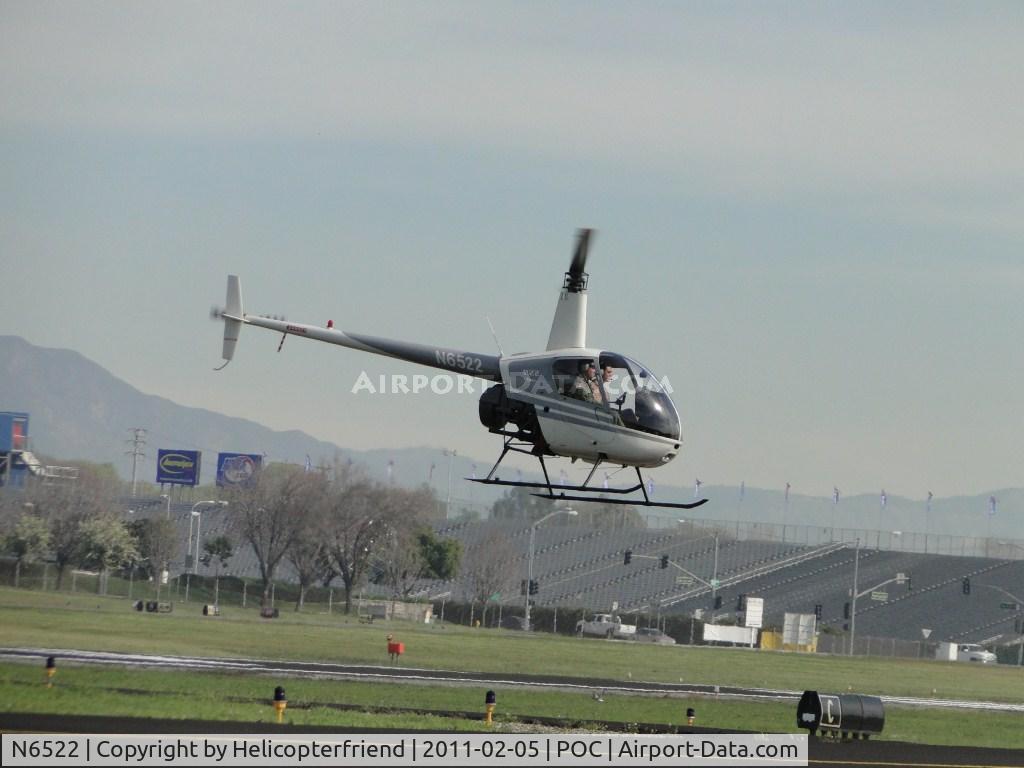 N6522, Robinson R22 Beta C/N 0522, Landed on the north of runway 26R and is air taxiing to helipad