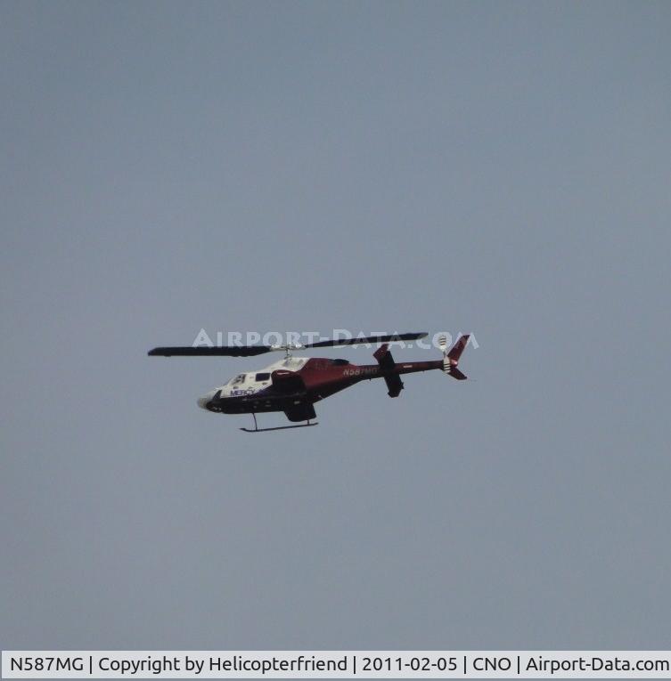 N587MG, 1987 Bell 222U C/N 47566, Crossing over the airport, heading northbound