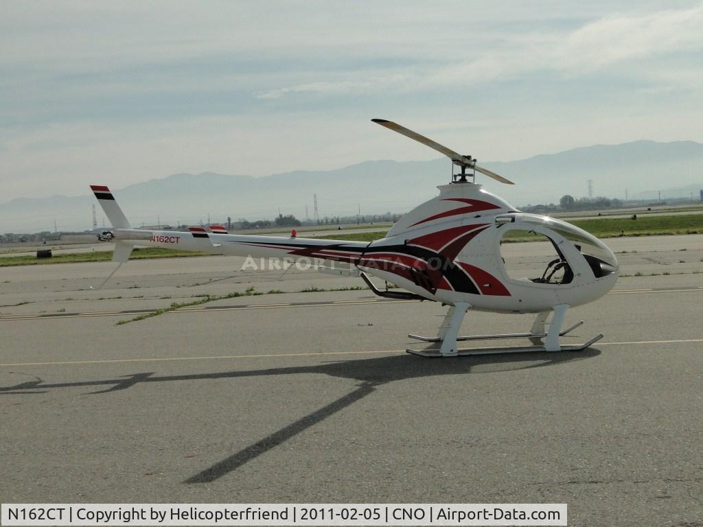 N162CT, 2008 Rotorway Exec 162F C/N 6445, Parked in the area north of runway 26R and west of the Tower waiting to take off