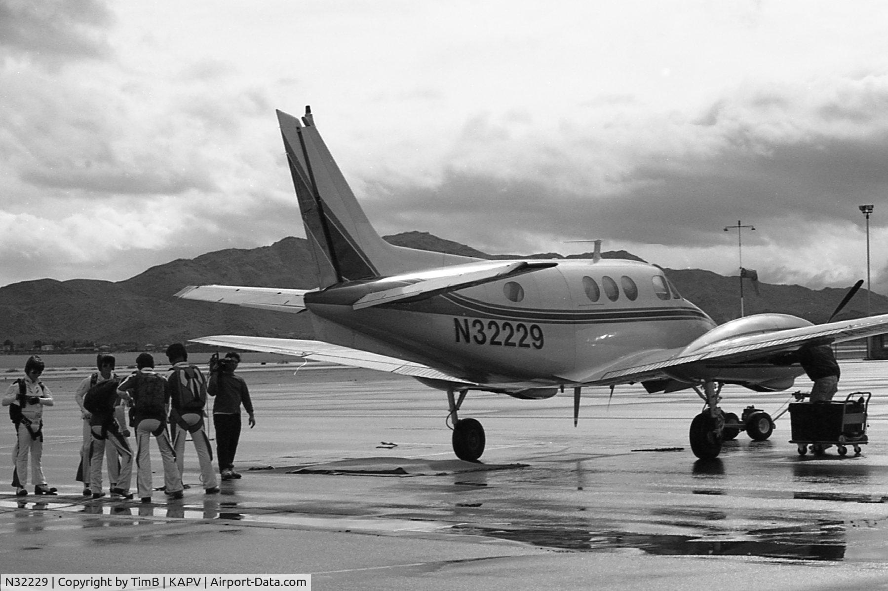 N32229, 1965 Beech 90 King Air C/N LJ-49, B&W photo of The Flyin' Elvi getting ready to board N32229 to go do a demo somewhere.  Photo taken at Apple Valley Skydive sometime in the late 1990s.