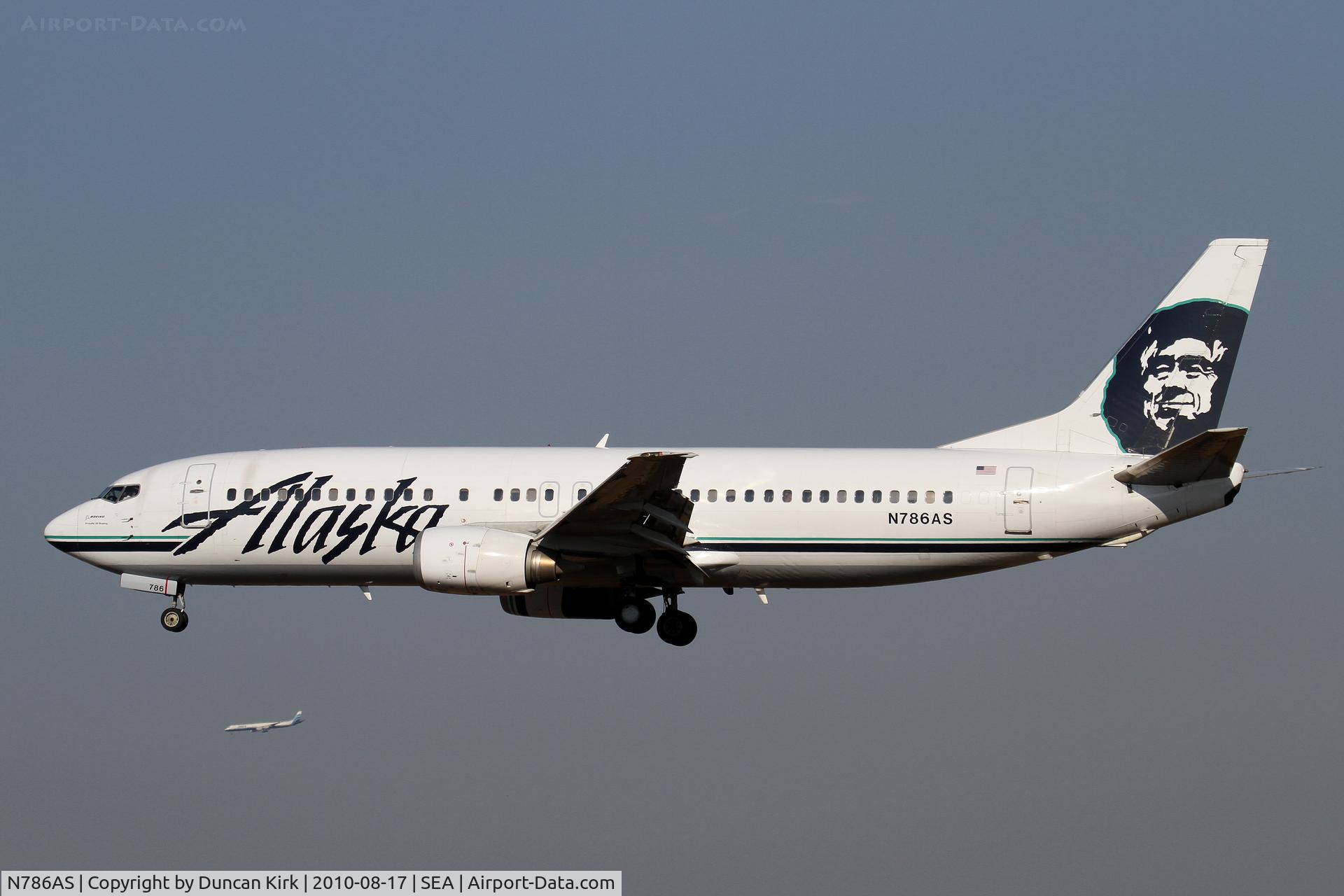 N786AS, 1990 Boeing 737-4S3 C/N 24795, An ATI DC-8 is in the distance on approach to BFI