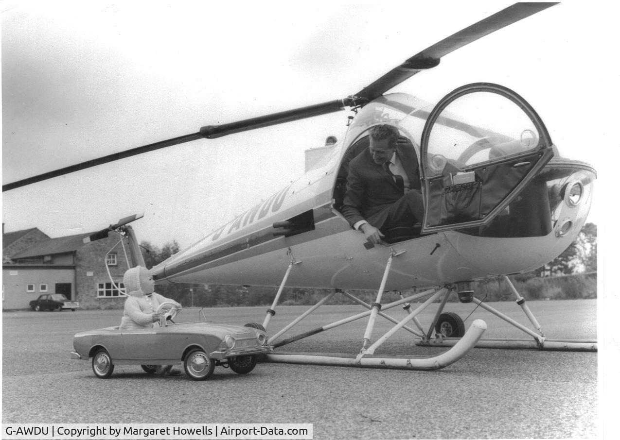 G-AWDU, 1968 Brantly B-2B C/N 481, taken at The De-Tabley Arms, Ribchester, Lancashire in approximately 1969/70. I'm the little girl in the convertible!!!