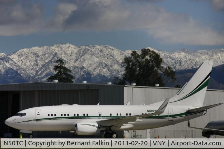 N50TC, Dassault Falcon 50 C/N 115, At Van Nuys today with the snow, in the moutains, in the background.