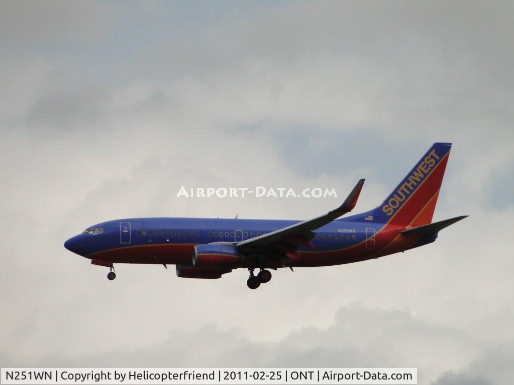 N251WN, 2006 Boeing 737-7H4 C/N 32510, On final to runway 26R during a light rain