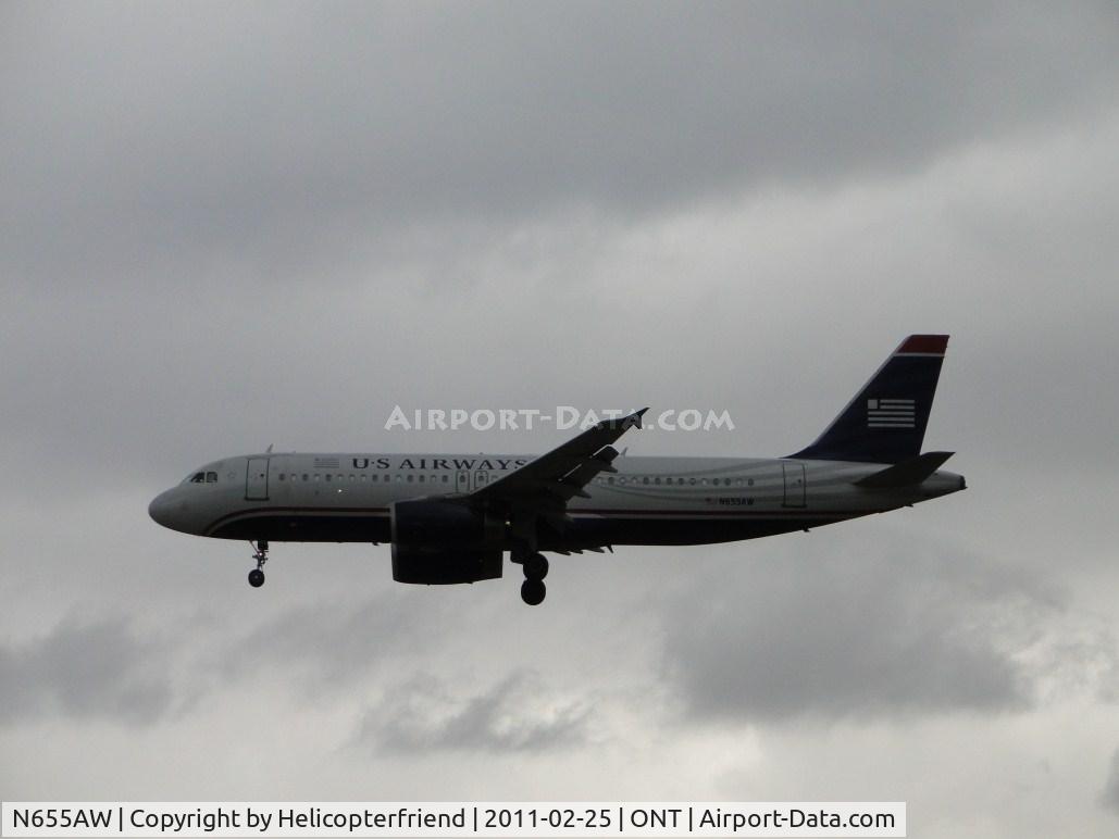 N655AW, 1999 Airbus A320-232 C/N 1075, On final to runway 26 under very cloudy conditions
