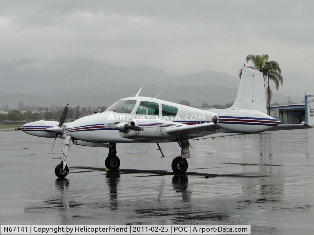 N6714T, 1959 Cessna 310C C/N 39014, parked in transient parking in the rain