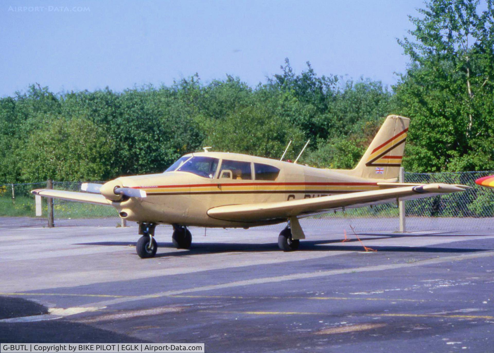 G-BUTL, 1960 Piper PA-24-250 Comanche C/N 24-2352, Smart Comanche on the main apron. Blackbushe EGLK 1985. This aircraft was previously registered G-ARLB and in 2003 this registration was restored to this aircraft. The aircraft is currently in a retro Piper Red, White and Black color scheme and has now be