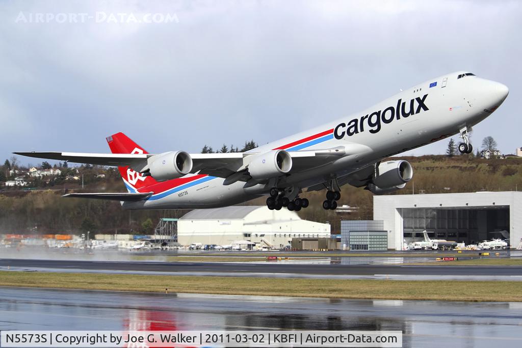 N5573S, 2010 Boeing 747-8R7F C/N 35807, Seen departing a soaked BFI is this 747-8R7F for Cargolux.