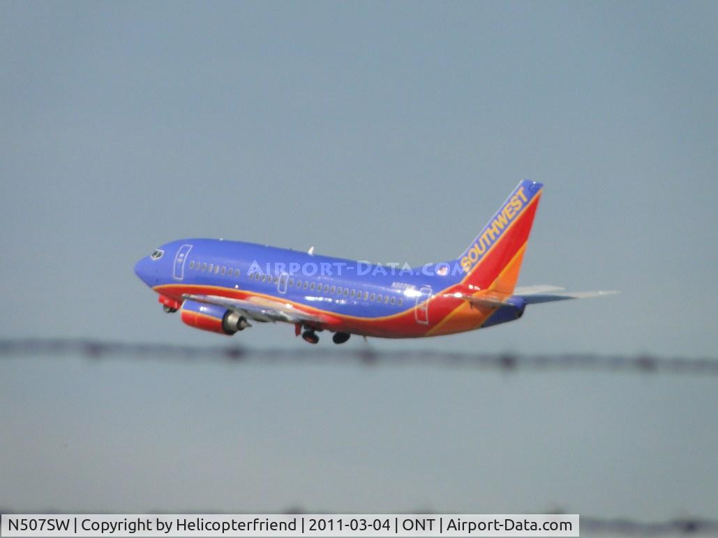 N507SW, 1990 Boeing 737-5H4 C/N 24184, Wheels coming up after take off from runway 26R