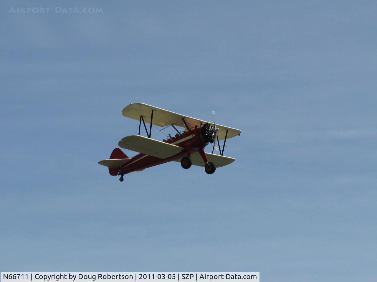 N66711, 1941 Boeing IB75A C/N 75-1675, 1941 Boeing Stearman IB75A, Jacobs R-755B2 275 Hp upgrade, restored & recovered, Restricted Experimental class, takeoff climb Rwy 22, Sammy waving
