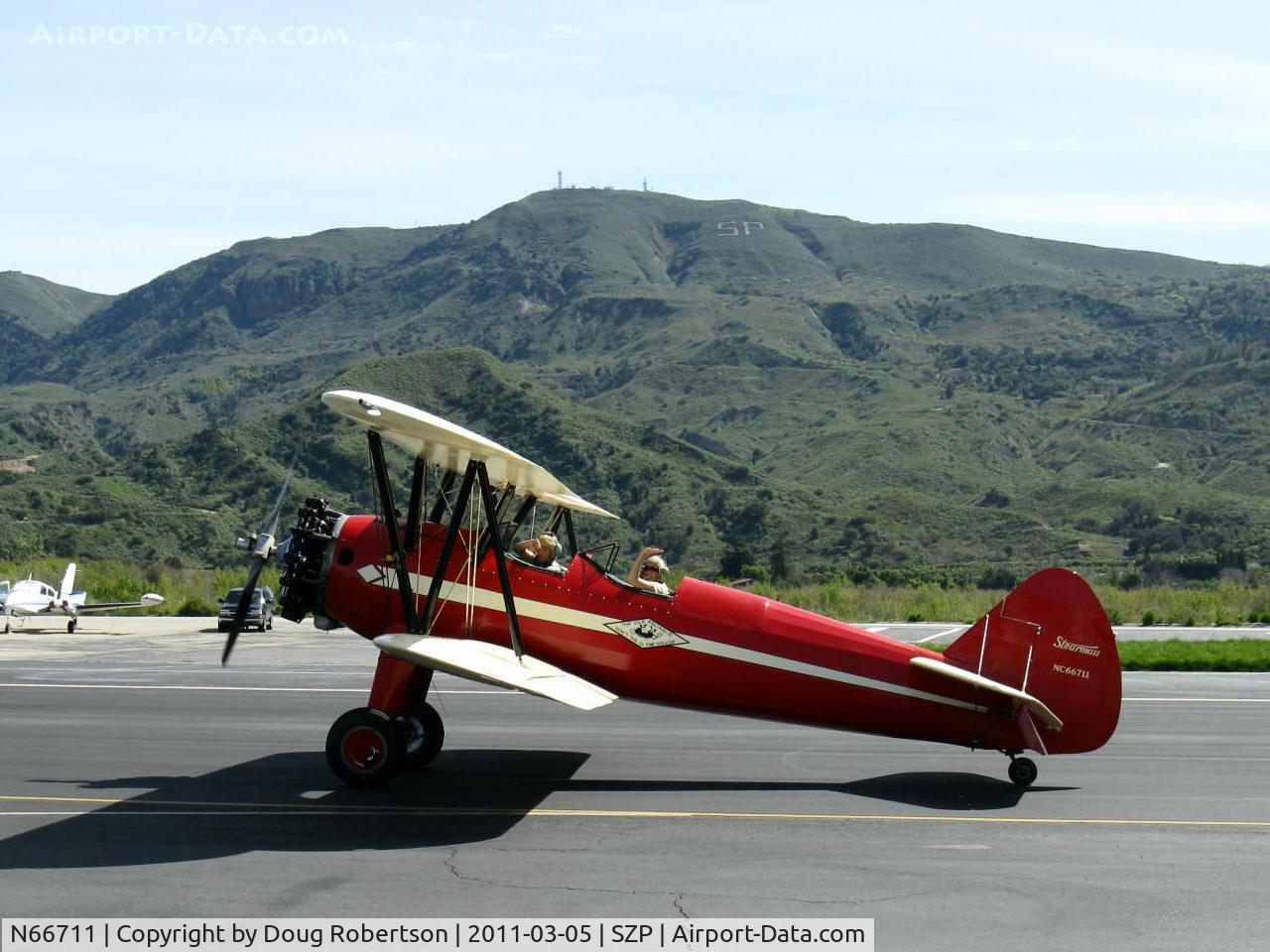 N66711, 1941 Boeing IB75A C/N 75-1675, 1941 Boeing Stearman IB75A, Jacobs R-755B2 275 Hp upgrade, Restored and recovered by Rowena's Flying Fabric Co. Taxi to 22, Sammy & Mom Rowena Mason waving