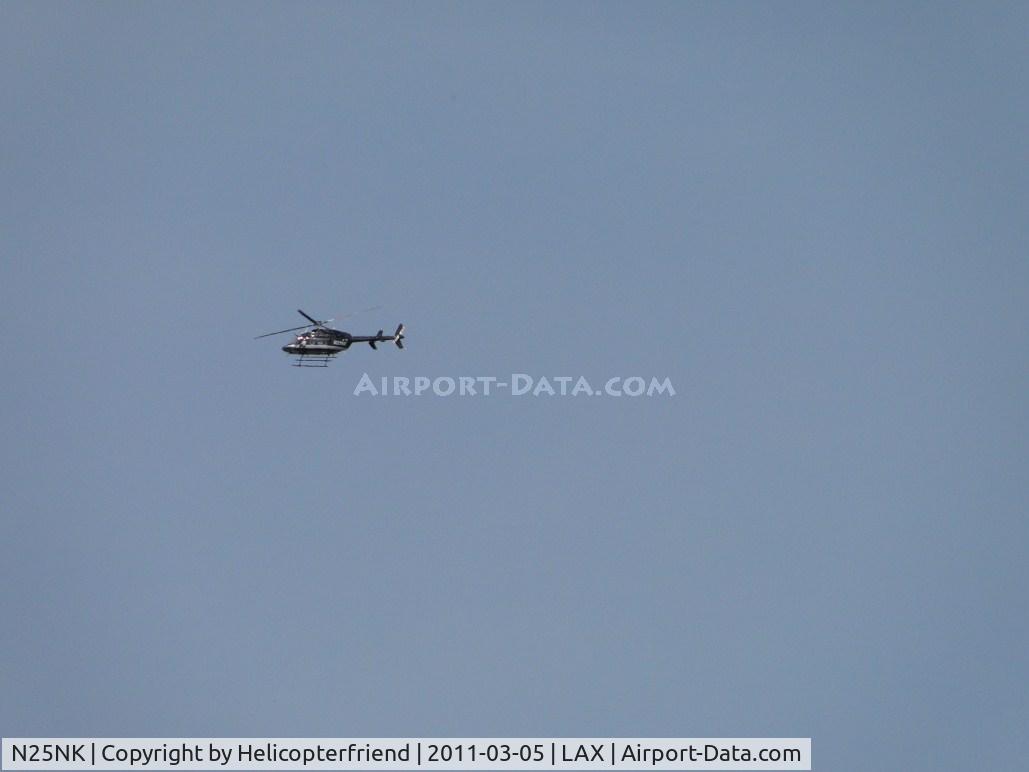 N25NK, 2008 Bell 407 C/N 53885, Passing over the City of Bell approximately 3/4 mile northeast of LAX runway approaches