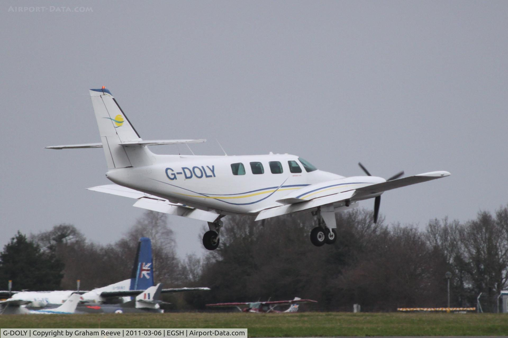 G-DOLY, 1982 Cessna T303 Crusader C/N T303-00107, About to touch down.