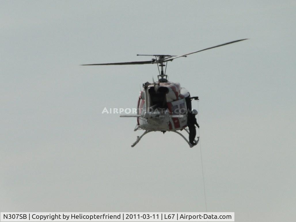 N307SB, 1975 Bell 212 C/N 30781, Cable and devices being lowered to personnel on the ground