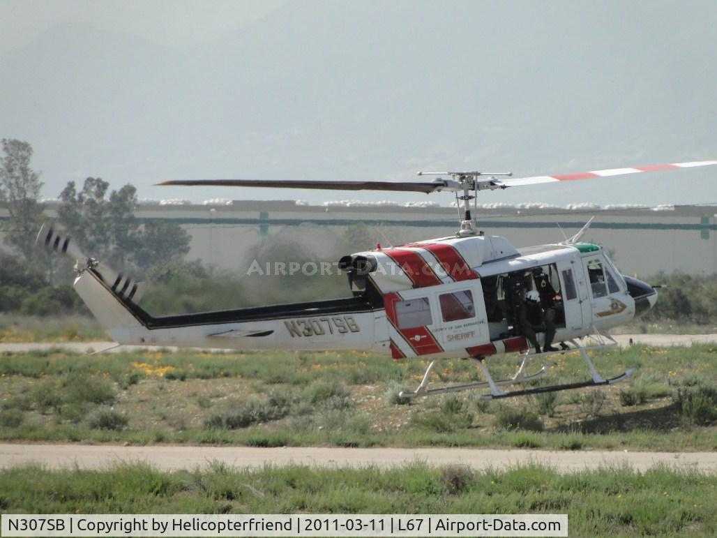 N307SB, 1975 Bell 212 C/N 30781, Setting both skids down in uneven terrain