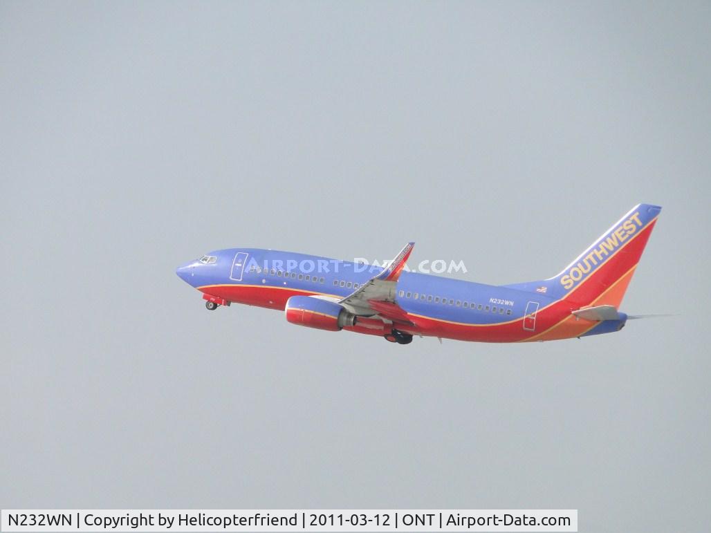 N232WN, 2006 Boeing 737-7H4 C/N 32500, Flt 534 heading to Oakland California. Wheels coming up after take off from runway 26R