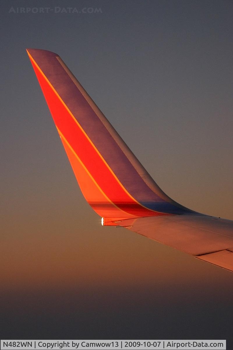 N482WN, 2004 Boeing 737-7H4 C/N 29852, In flight somewhere over the USA. Taken just after sunset as the colors shimmered off the wing.