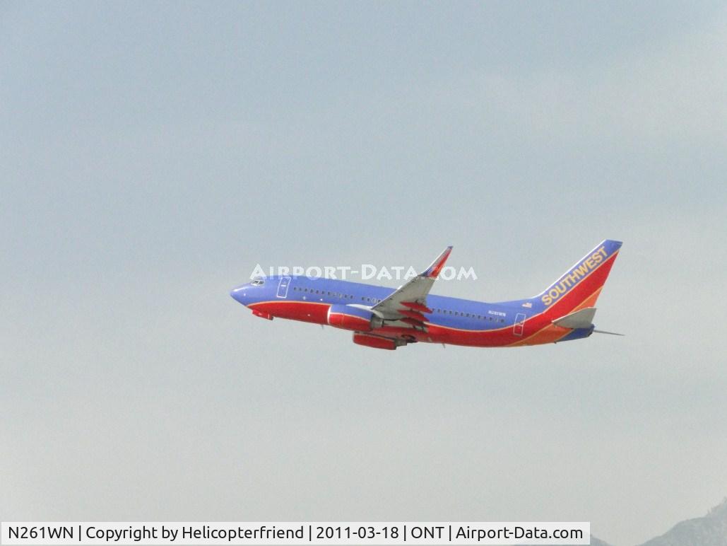 N261WN, 2006 Boeing 737-7H4 C/N 32517, Wheels coming up after take off from runway 26R and heading west