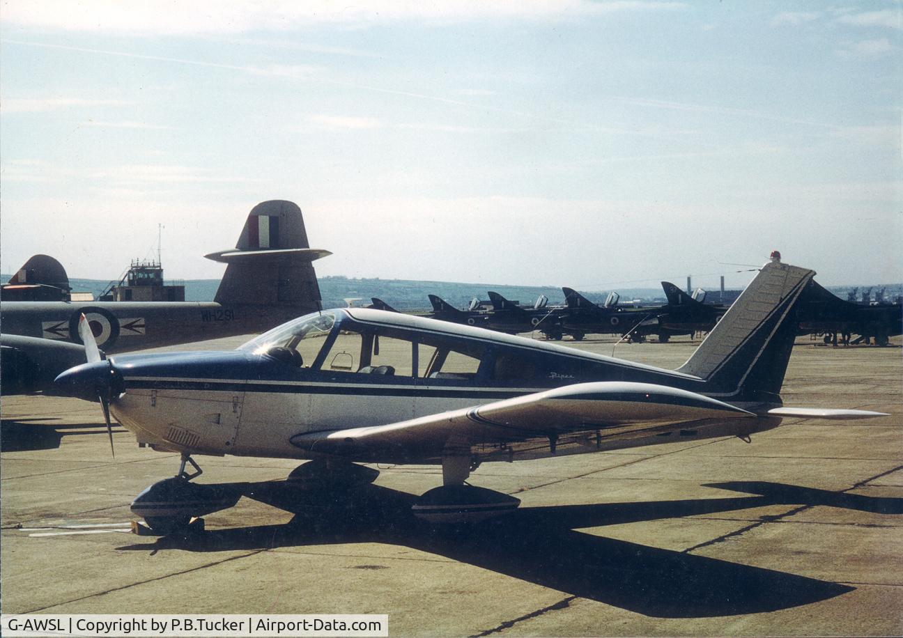 G-AWSL, 1968 Piper PA-28-180 Cherokee C/N 28-4907, G-AWSL parked on the apron at RAF Chivenor, North Devon, UK, next to Meteors and Hunters, while on a visit from its home airfield of Fairoaks, Surrey. 1974 approx.