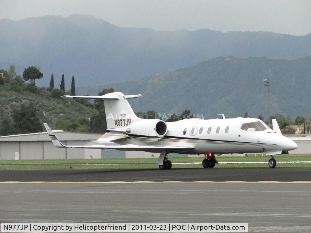 N977JP, 1997 Learjet 31A C/N 140, Eastbound on taxiway Sierra heading to runway 26L for take off before the rain arrives