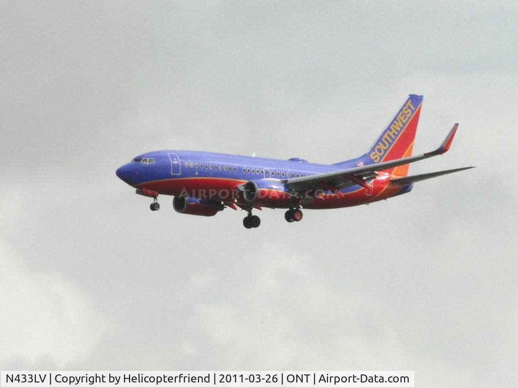 N433LV, 2003 Boeing 737-7H4 C/N 33716, Notice pod on top of cabin, maybe the WIFI system thet Southwest is using, possibly ROW 44 equipment