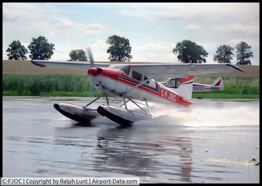 C-FJOC, 1957 Cessna 180A C/N 32816, Departure from Oshkosh lake - 1987.
