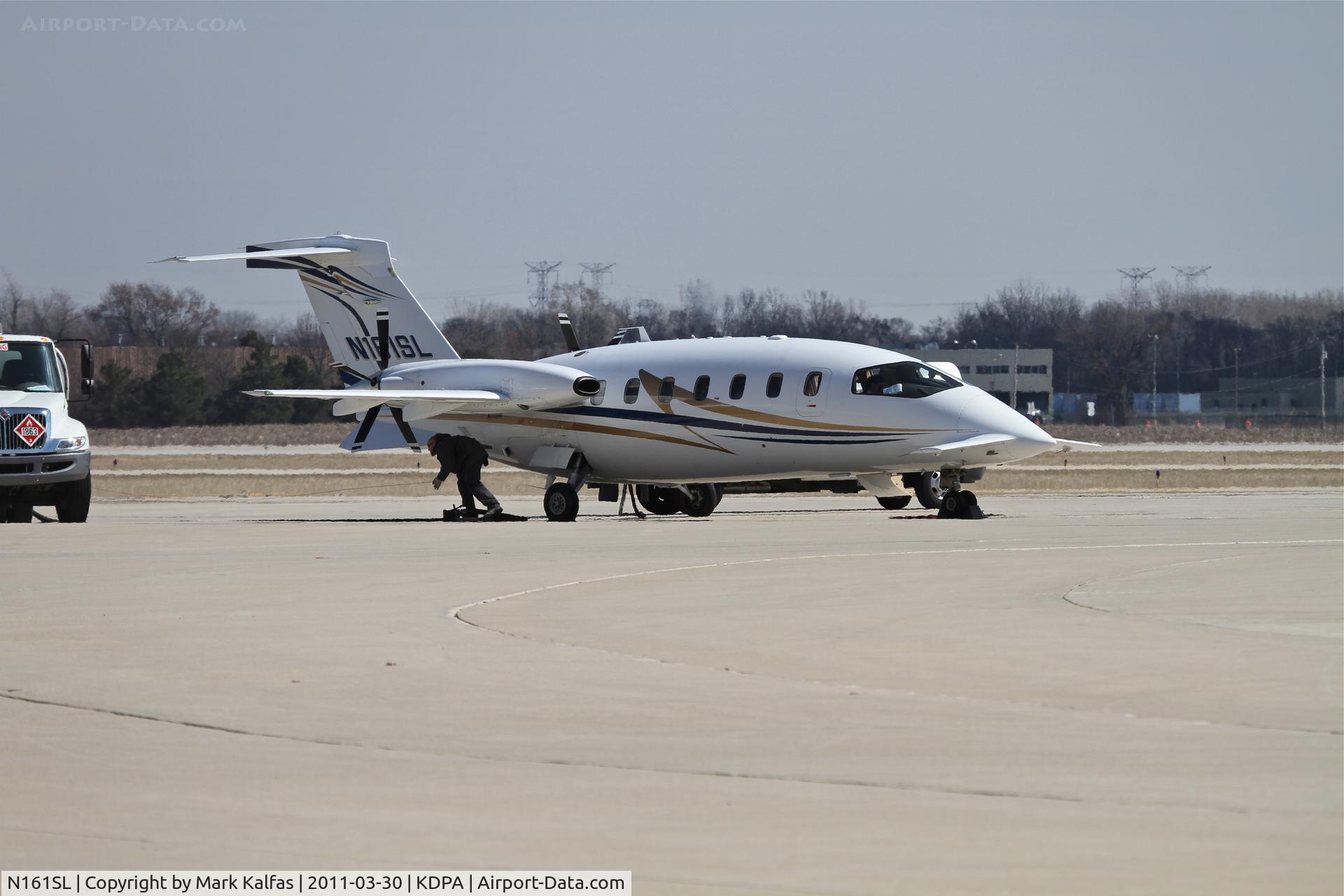 N161SL, 2007 Piaggio P-180 C/N 1128, Avantair Piaggio P180, VNR161 preparing for a trip from KDPA to KOSU - ramp personnel disconnecting ground wire after refueling.