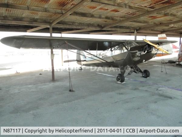 N87117, 1943 Piper L-4J Grasshopper (J3C-65D) C/N 13452, Parked in the shaded open parking area
