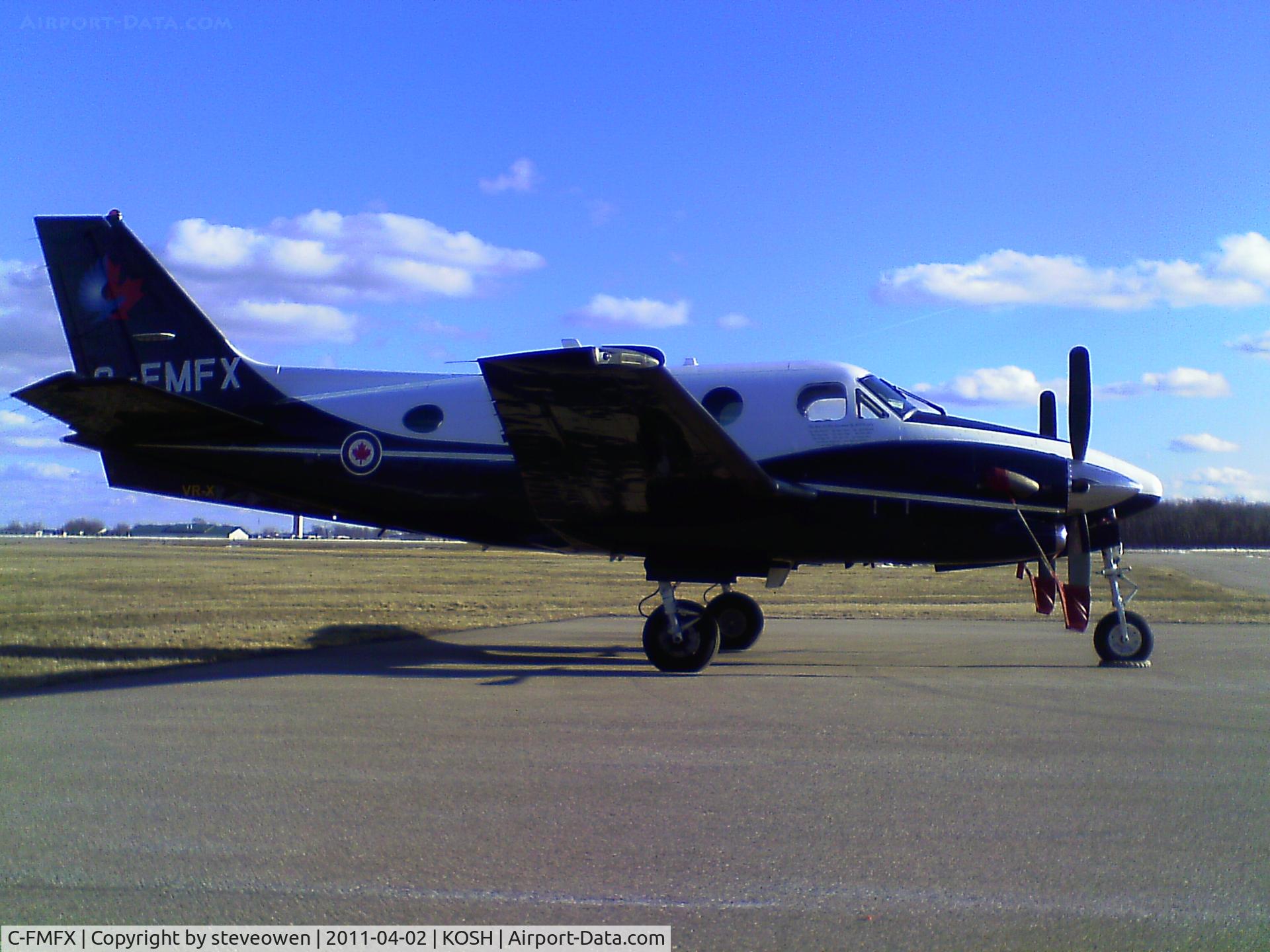 C-FMFX, 2005 Beech C90A King Air C/N LJ-1747, Taken at the Hilton Hotel ramp thru a fence with bad sun angle