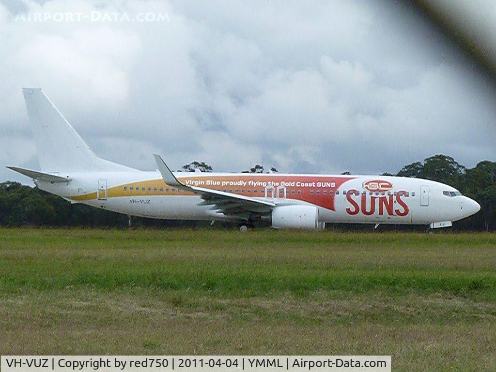 VH-VUZ, 2010 Boeing 737-8FE C/N 39921, Virgin Blue logojet for the Gold Coast Suns, a new franchise in the Australian Football League, at the holding point for runway 16 at Melbourne (Tullamarine). Taken through the perimeter fence.