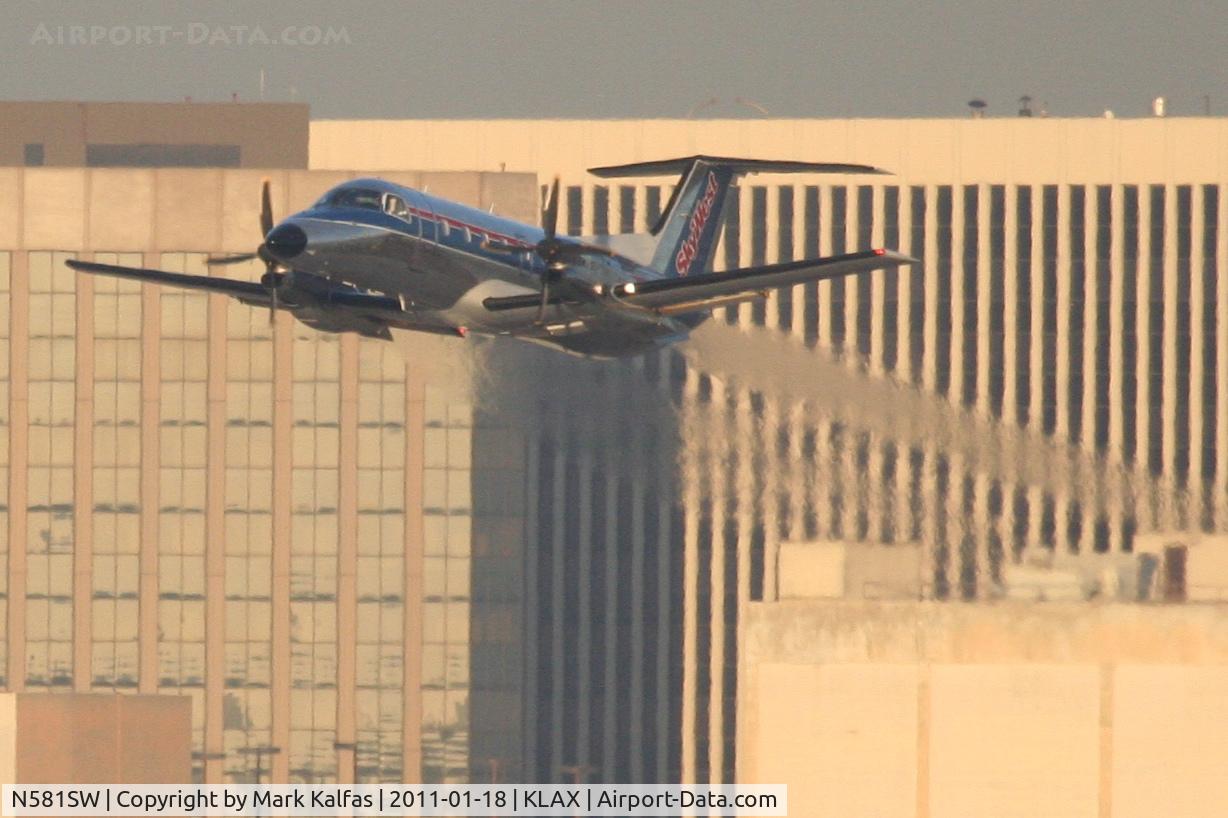 N581SW, 1999 Embraer EMB-120ER Brasilia C/N 120349, SkyWest/United Express Embraer EMB-120ER, SKW7015 departing RWY 25R KLAX enroute to KCRQ.