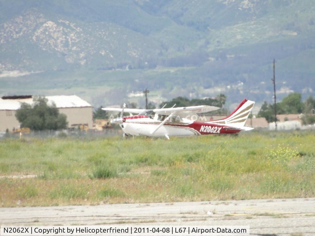 N2062X, 1965 Cessna 182H Skylane C/N 18256162, Partially hidden by the area between the taxiway and runway 24