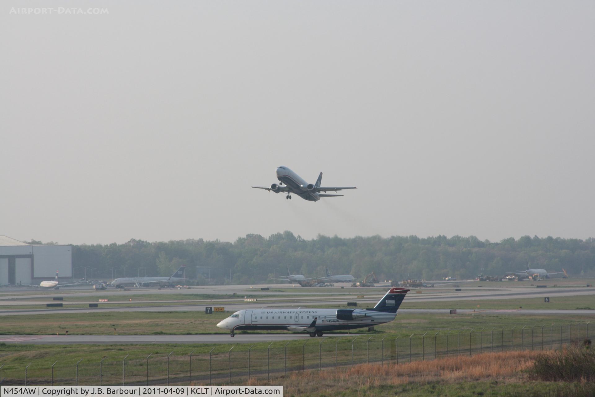 N454AW, 2003 Bombardier CRJ-200LR (CL-600-2B19) C/N 7842, 454UW TAKING OFF IN THE BACKGROUND