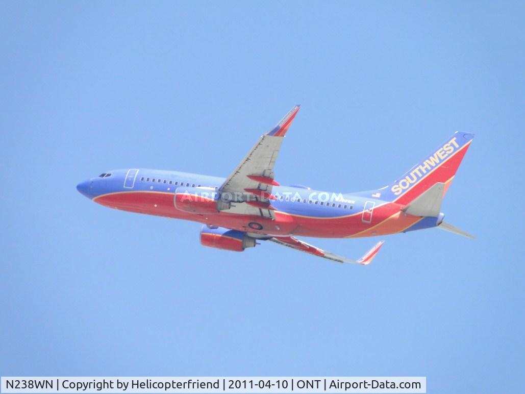 N238WN, 2005 Boeing 737-7H4 C/N 34713, Wheels up and heading west from runway 26R