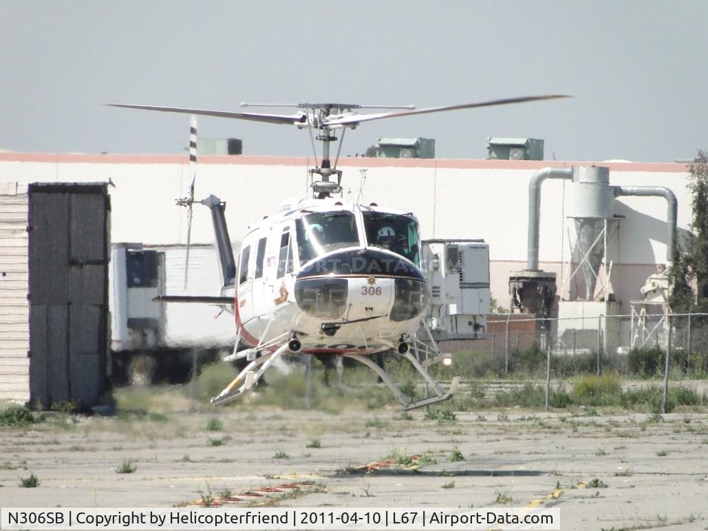 N306SB, 1971 Bell UH-1H Iroquois C/N 13041, Appear to be checking out photographer, but believe they were checking for incoming aircraft