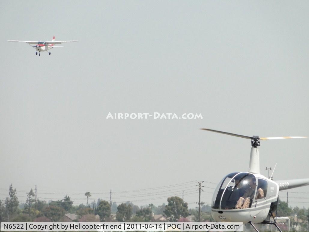N6522, Robinson R22 Beta C/N 0522, Robinson hovering awaiting N4355L to land before taxiing to runway 26L for take off